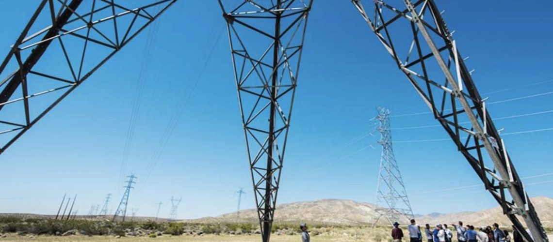 NREL-photo-of-people-looking-at-transmission-towers-and-lines-1200x701.jpg